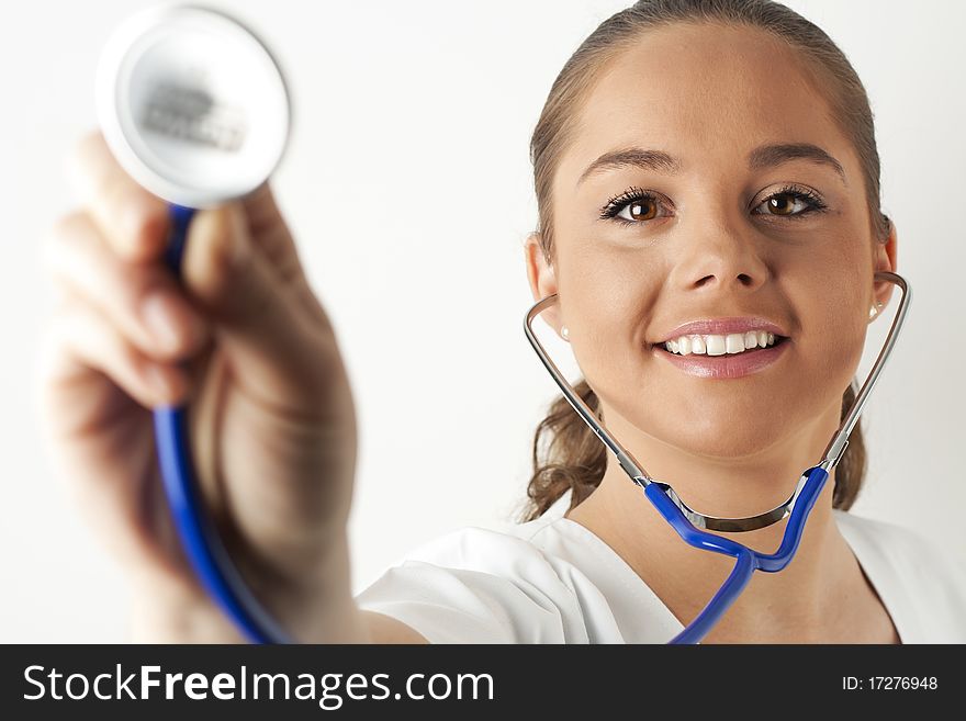 Young woman doctor or nurse holding a stethoscope. Young woman doctor or nurse holding a stethoscope