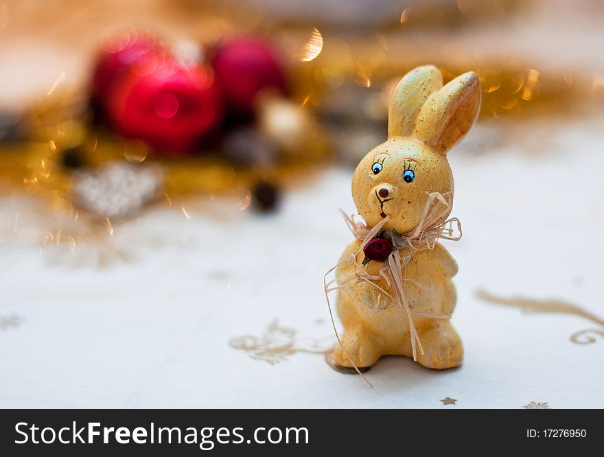 Yellow bunny christmas toy on a shiny background. Yellow bunny christmas toy on a shiny background