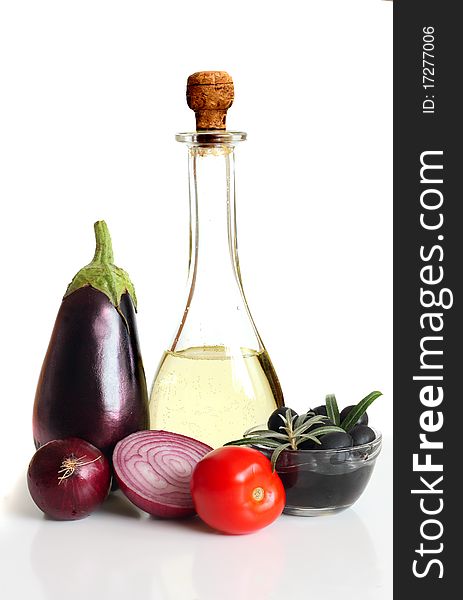 Composition with raw vegetables and olive oil on white