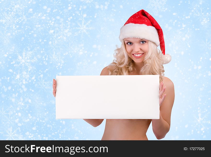 Beautiful christmas woman in santa hat holding empty board