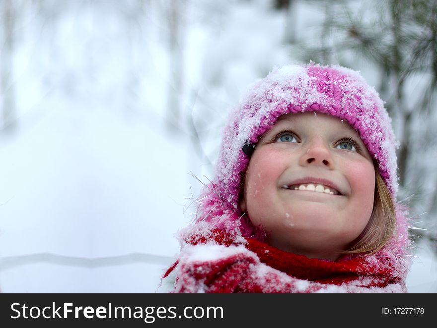 Little girl in winter pink hat in snow . Little girl in winter pink hat in snow .