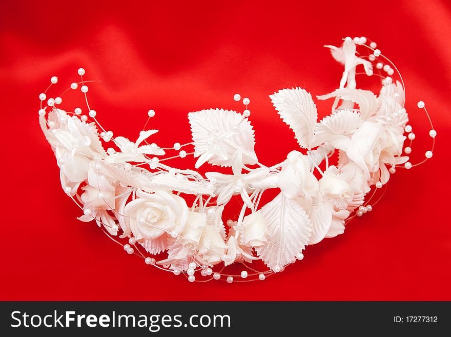 Bride's wreath of white flowers on a red background