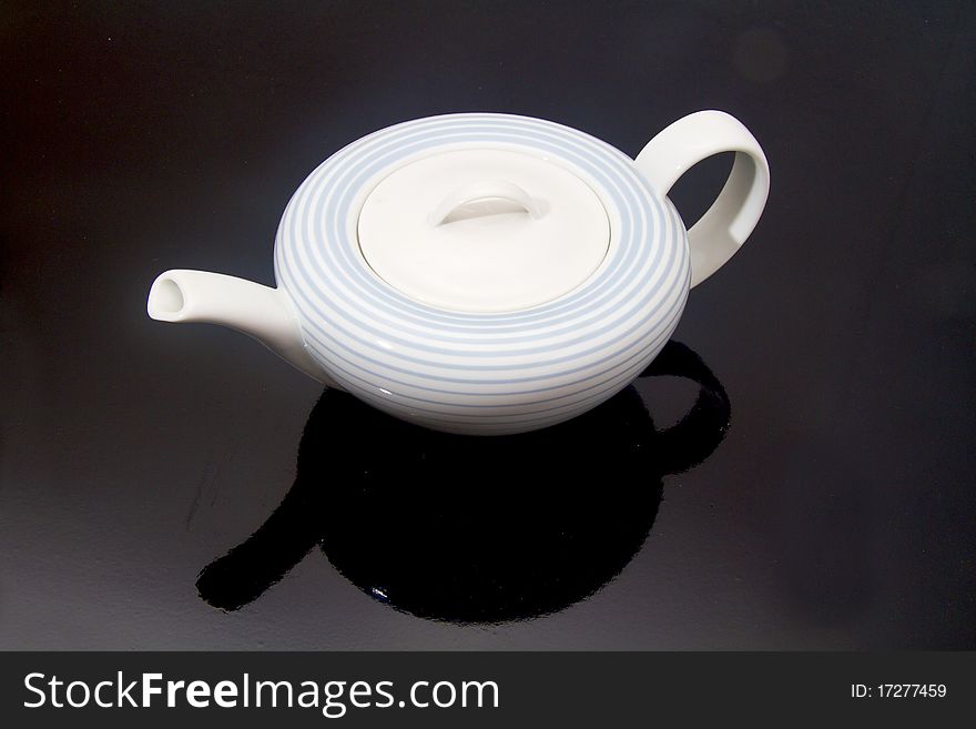 White porcelain teapot on a black background