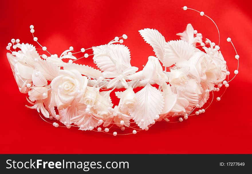 Bride's wreath of white flowers on a red background