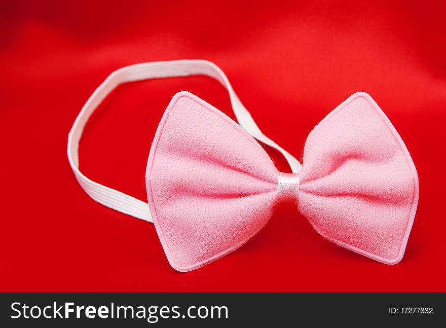 Pink butterfly on a tuxedo with a red background