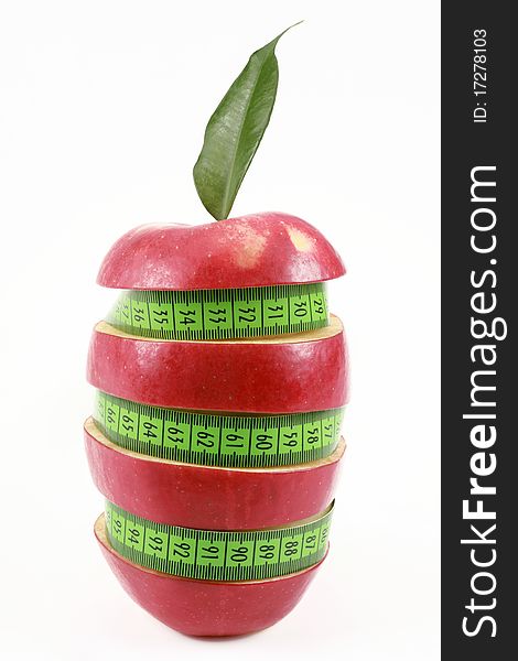 Red apple and green measured tape is isolated on a white background