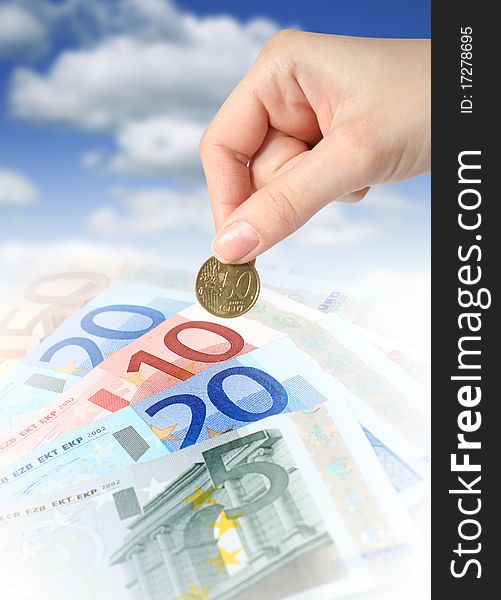 Financial concept. Euro cash and hand with coin. Financial concept. Euro cash and hand with coin.