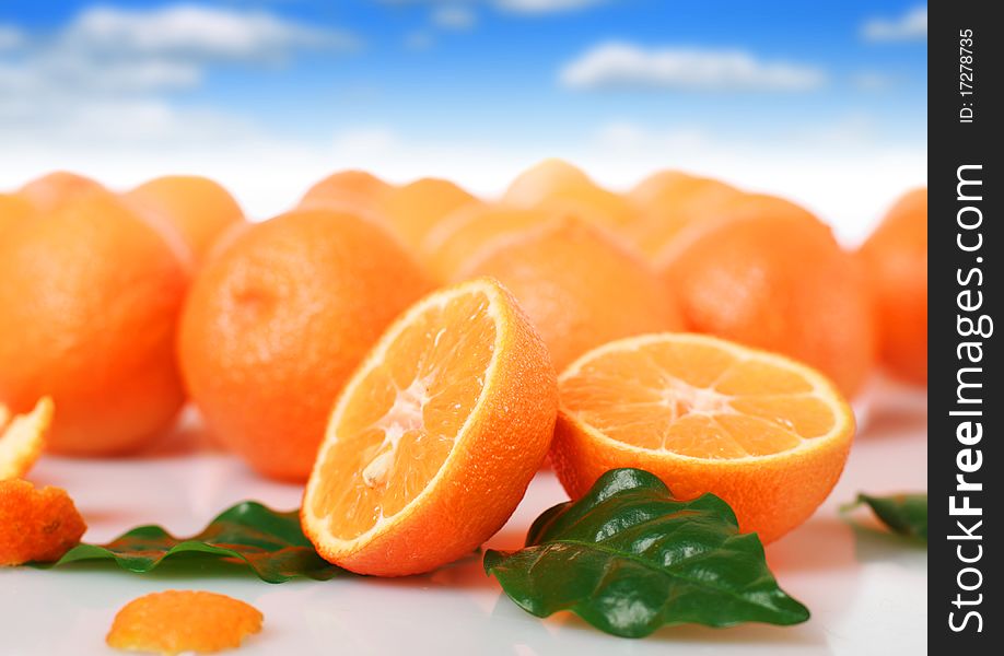 Fresh oranges over blue sky background. Fresh oranges over blue sky background.