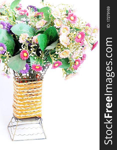 A bundle of artificial flowers isolated on a white background