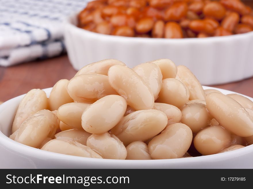 White canned beans in a white ceramic dish. White canned beans in a white ceramic dish.