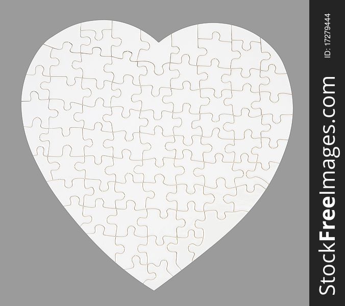 The empty puzzle isolated on gray - good as template for prints and symbol of love