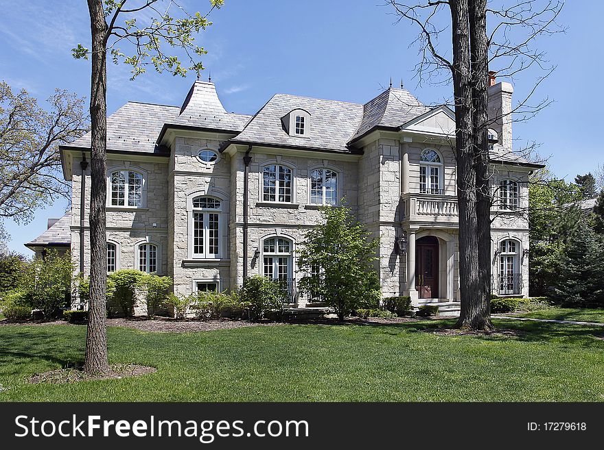 Luxury stone home with front balcony and columns. Luxury stone home with front balcony and columns