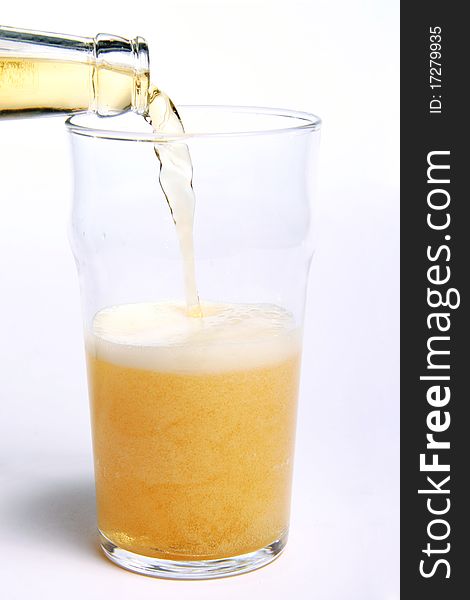 Pouring beer into a glass isolated on white