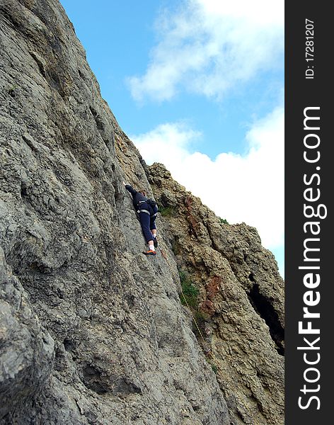 Girl rock climber conquers mountain