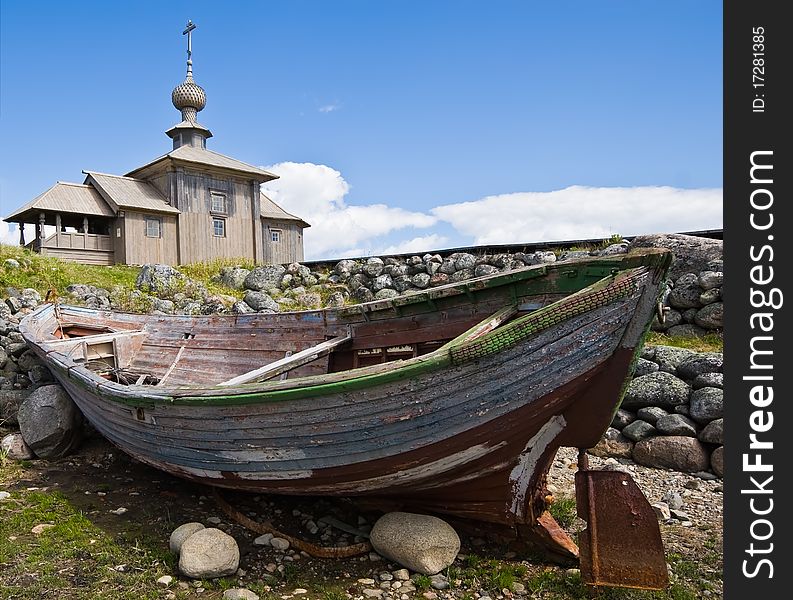 Wooden Orthodox chapel and a boat on Greater Zayatsky island of Solovki islands, White Sea, Northern Russia. Wooden Orthodox chapel and a boat on Greater Zayatsky island of Solovki islands, White Sea, Northern Russia.