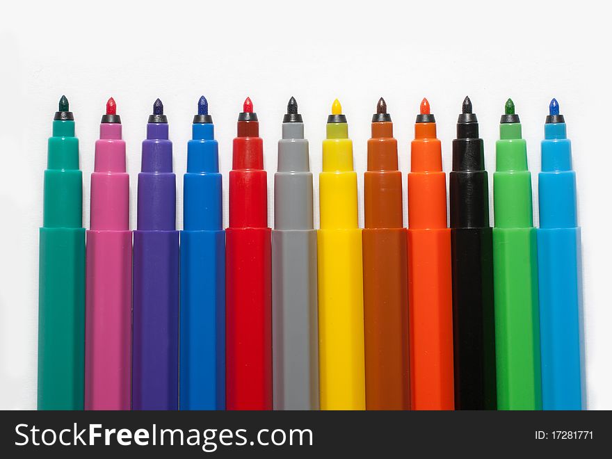 A row of coloured felt-tip pens on white background. A row of coloured felt-tip pens on white background