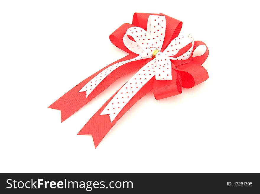 Perspective of isolated red and white bow for holiday gift box over white