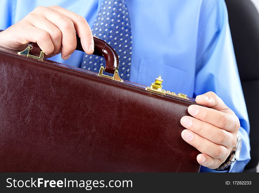 Businessman holding a brown case. Businessman holding a brown case