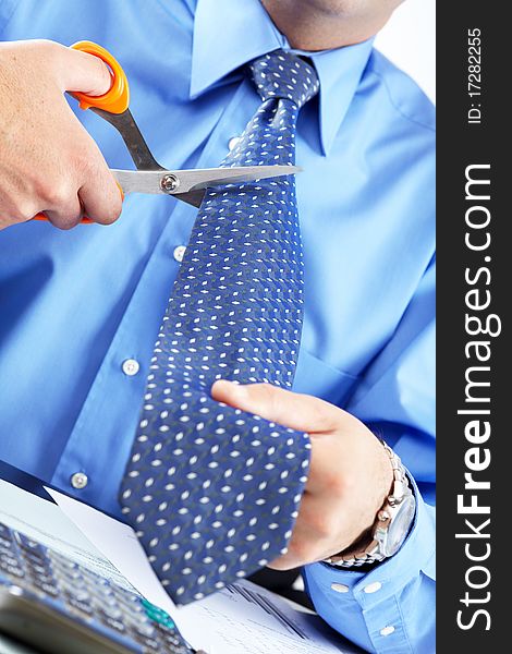 Businessman cutting the tie by scissors