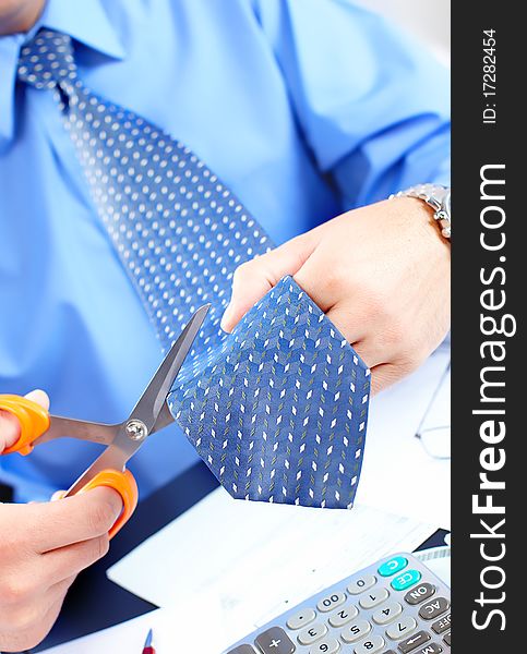 Businessman cutting the tie by scissors. Business