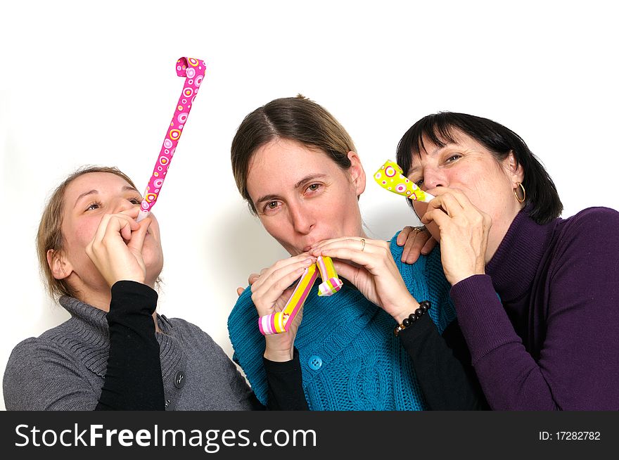 Two young women and her mother celebrating New year's eve. Shot taken in front of white background. Two young women and her mother celebrating New year's eve. Shot taken in front of white background