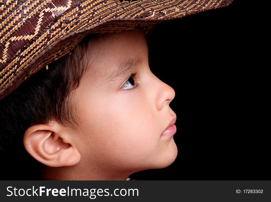 Six years old child looking with hat on black background. Six years old child looking with hat on black background