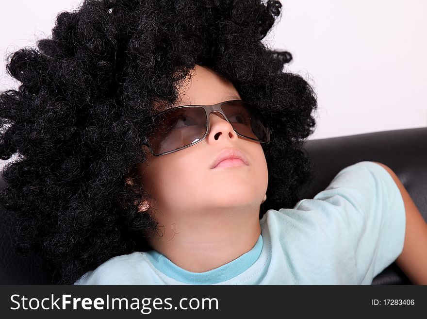 Relaxed child resting in a wig and glasses
