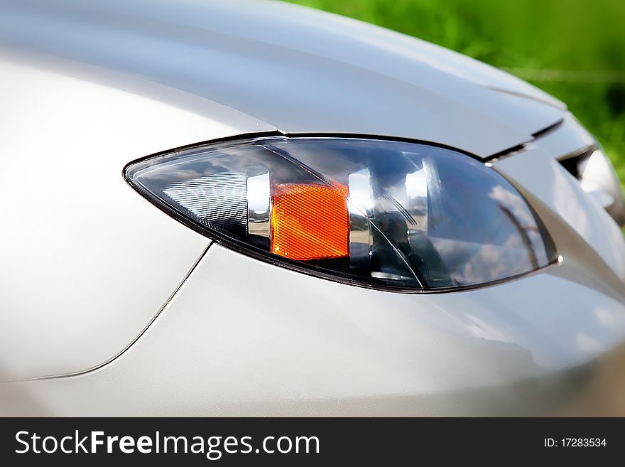 Front of the car with the lamp over green background. Front of the car with the lamp over green background