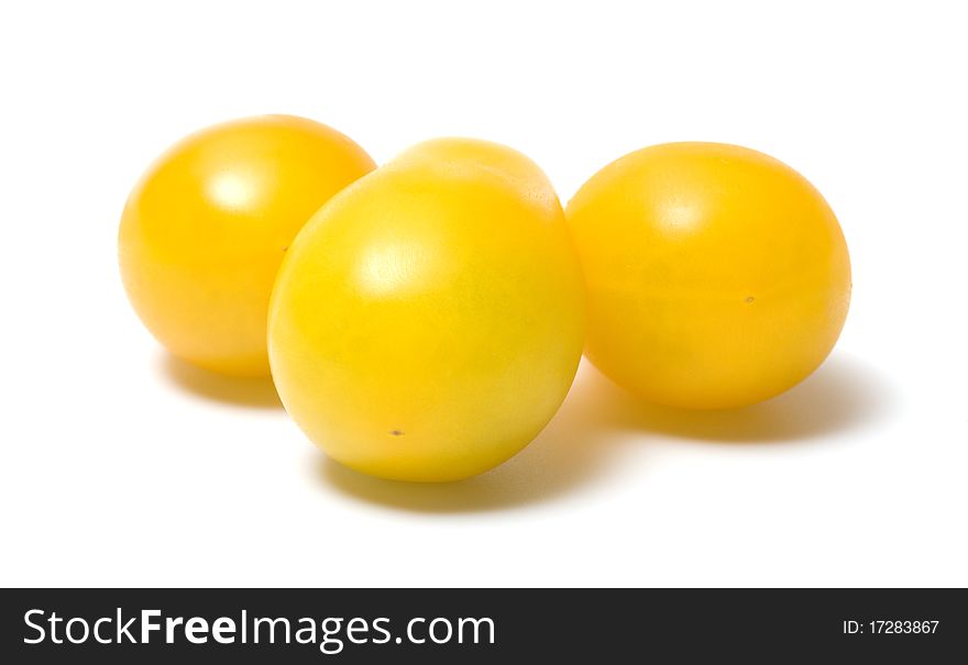 Three yellow tomato on a white background. Three yellow tomato on a white background.
