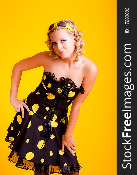 Beautiful blonde haired woman on yellow background