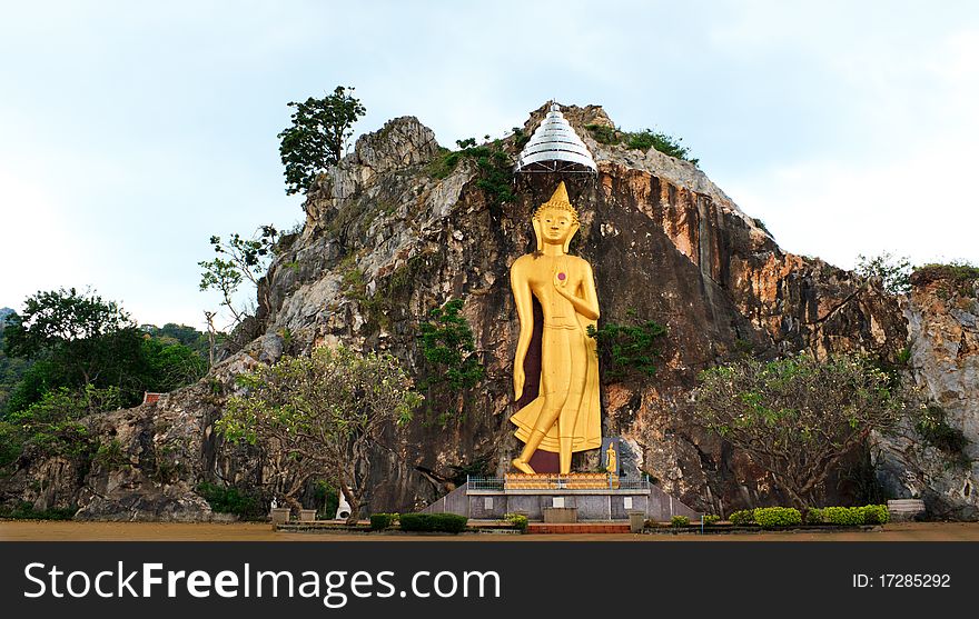 The Big Golden Buddha on stone mountain in Ratchaburi, Thailand