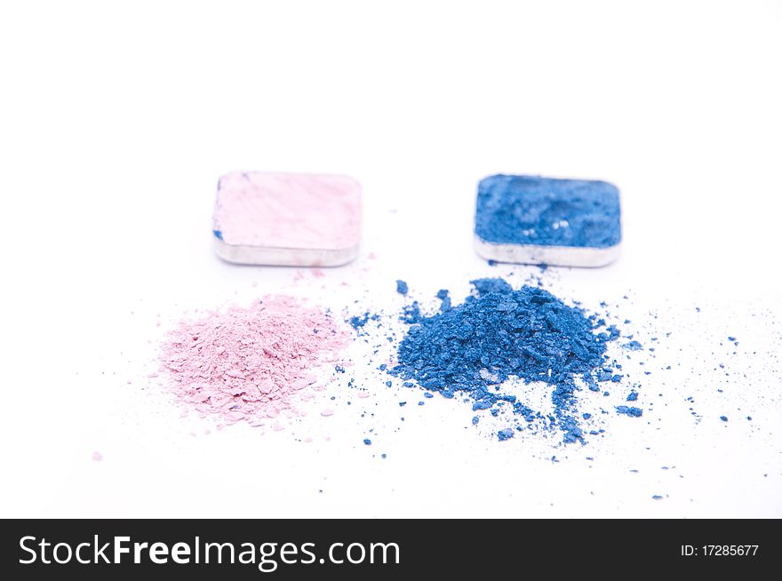 Crushed colored makeup on white background
