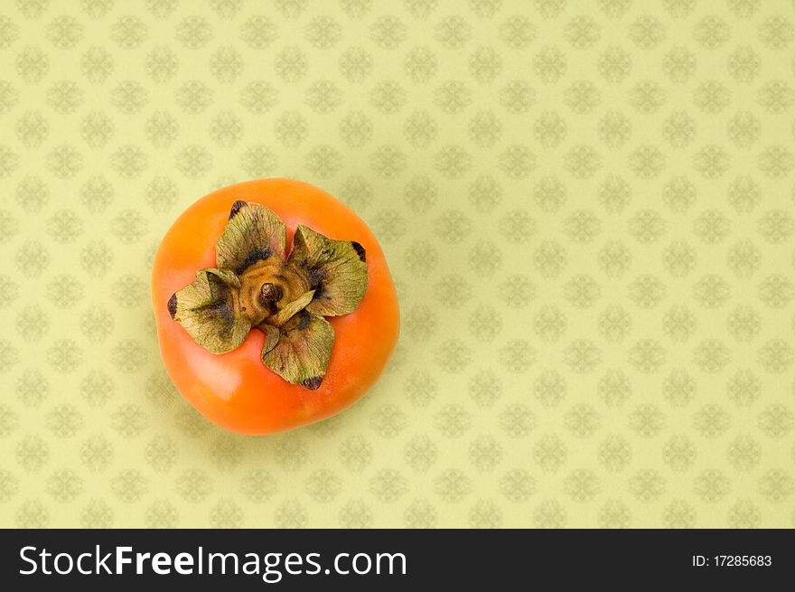 Juicy persimmon on green background