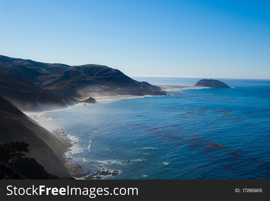 Beautiful west coast shoreline with rolling hills and white sand beach. Beautiful west coast shoreline with rolling hills and white sand beach