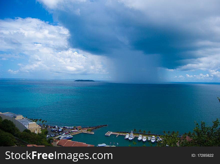 Dark rain cloud over open ocean. Dark rain cloud over open ocean