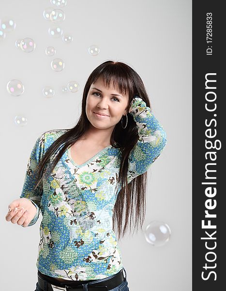 Smiling brunette girl and soap bubbles. Smiling brunette girl and soap bubbles