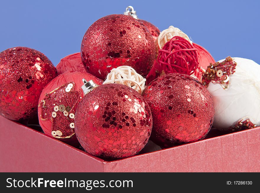 Gift box filled with ornamental red balls. shooted in studio using strobes