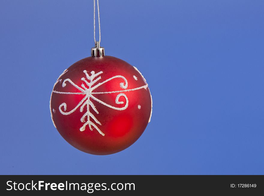 Isolated christmass red ball shooted on a blue background