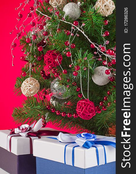 Christmas tree and gifts shooted in studio with red background