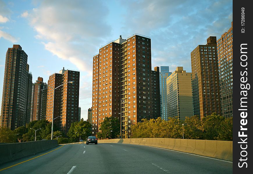Along FDR drive, early morning when it's barely empty. with blue summer sky and open road way.