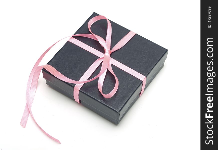 Gift black box tied with satin ribbon on gray