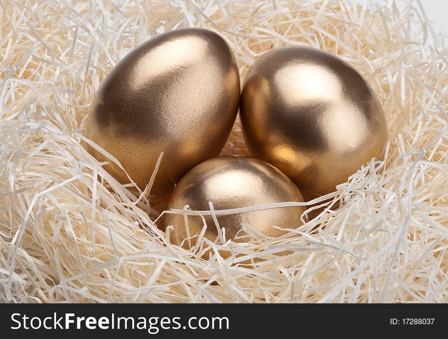 Three golden eggs in the bird's nest. Three golden eggs in the bird's nest
