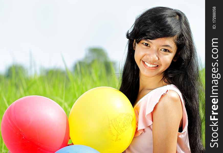 Portrait of teenage girl smiling while holding any balloons. Portrait of teenage girl smiling while holding any balloons