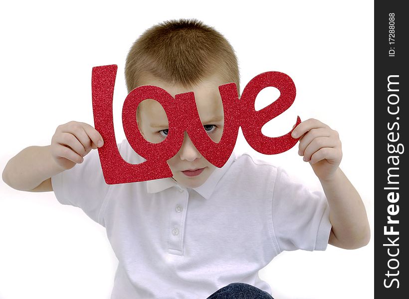 Boy holding a love sign peekig through the letters. Boy holding a love sign peekig through the letters