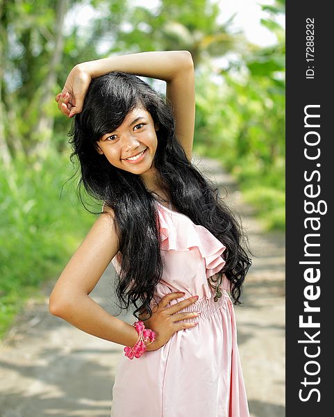 Portrait of young exotic girl smiling in green nature. Portrait of young exotic girl smiling in green nature