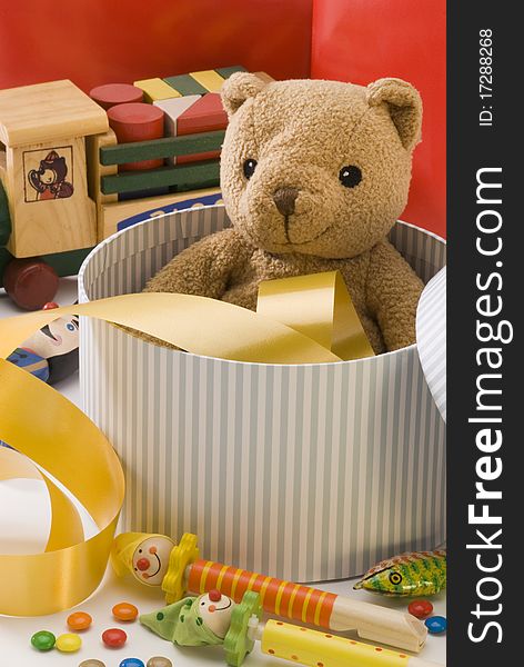 Teddy bear and other vintage toys in a box