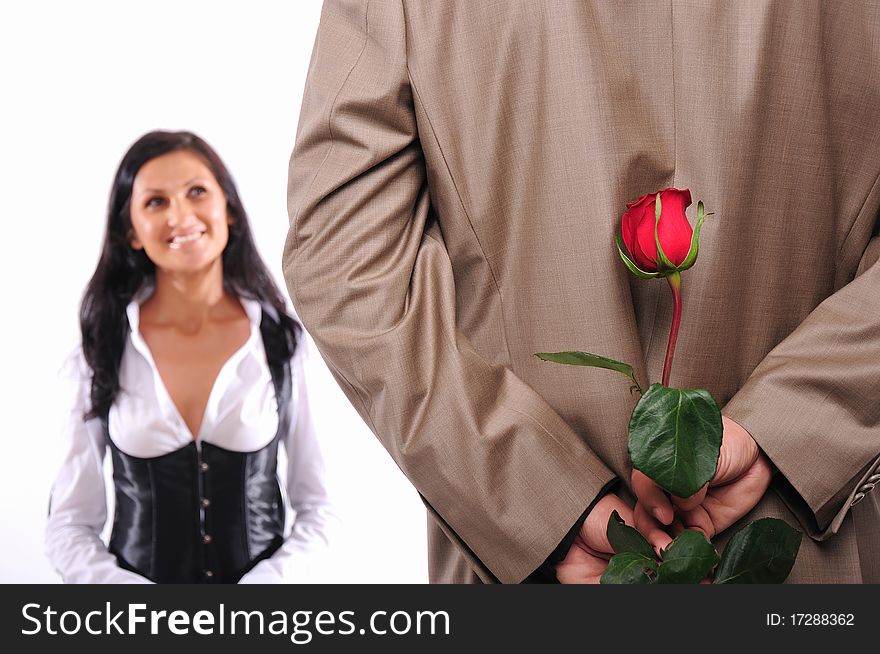 The young man gives his girlfriend a rose in honor of Valentine's Day