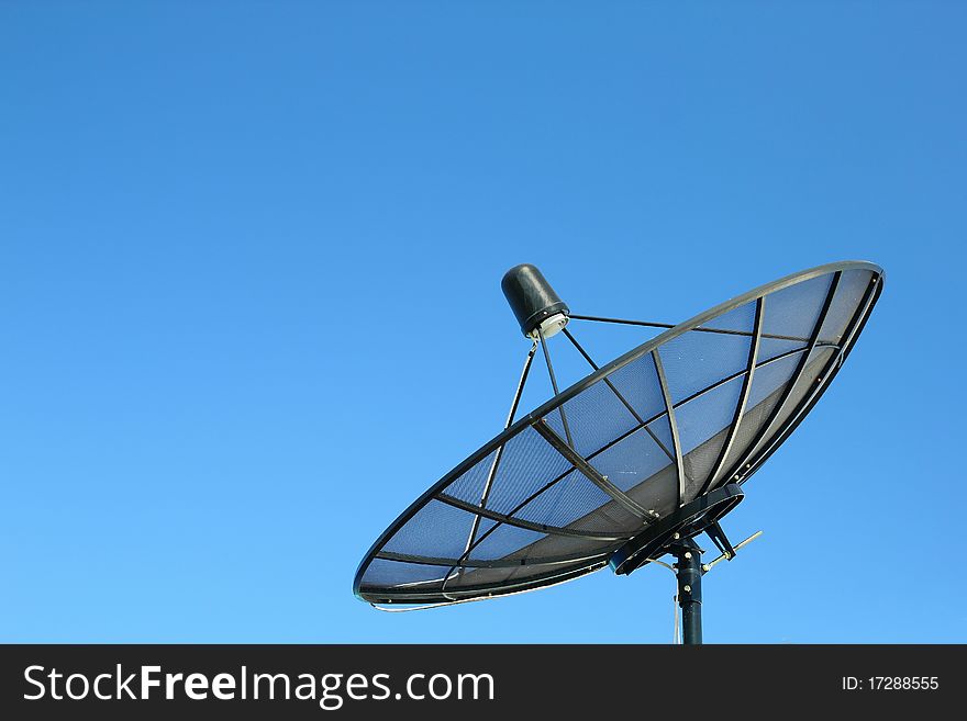 Satellite dish on blue sky background