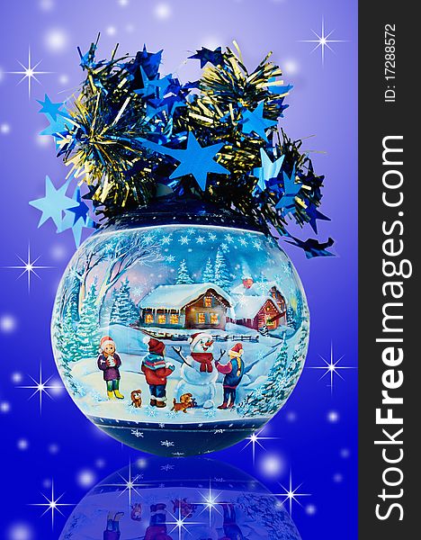 Christmas ball with the image of children doing a snowball. Decoration is represented on a blue background with stars. Christmas ball with the image of children doing a snowball. Decoration is represented on a blue background with stars.