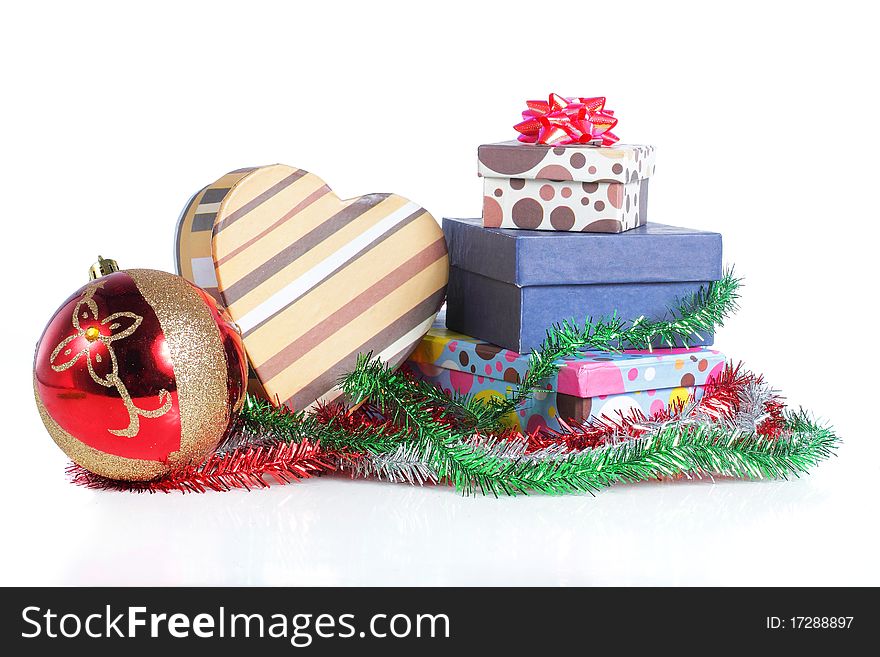 A pile of Christmas ball and gifts isolated on white background. A pile of Christmas ball and gifts isolated on white background.